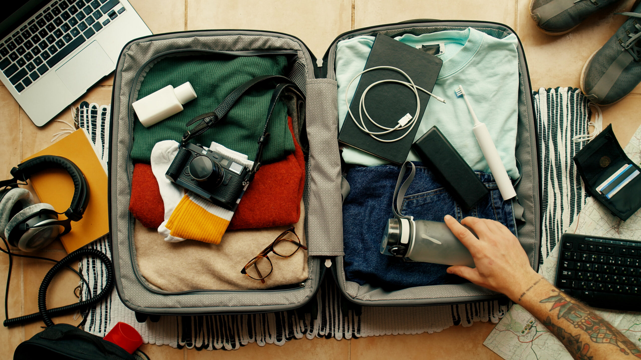 Man packs suitcase ready for adventure travel trip