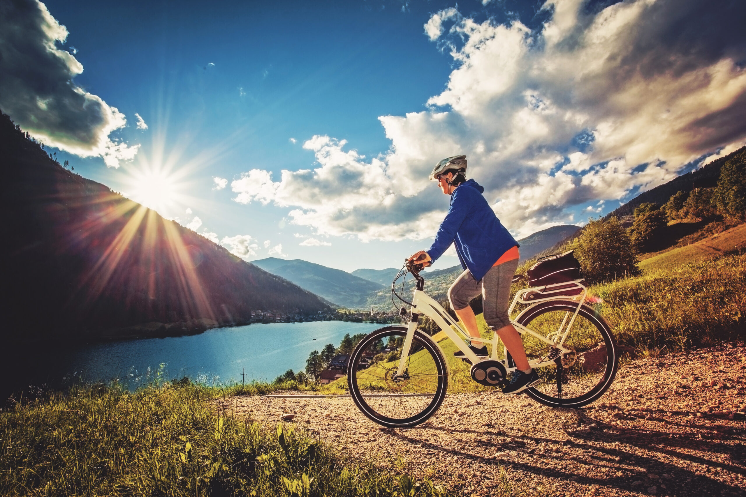 woman on e-bike enjoying view to a beautiful lake