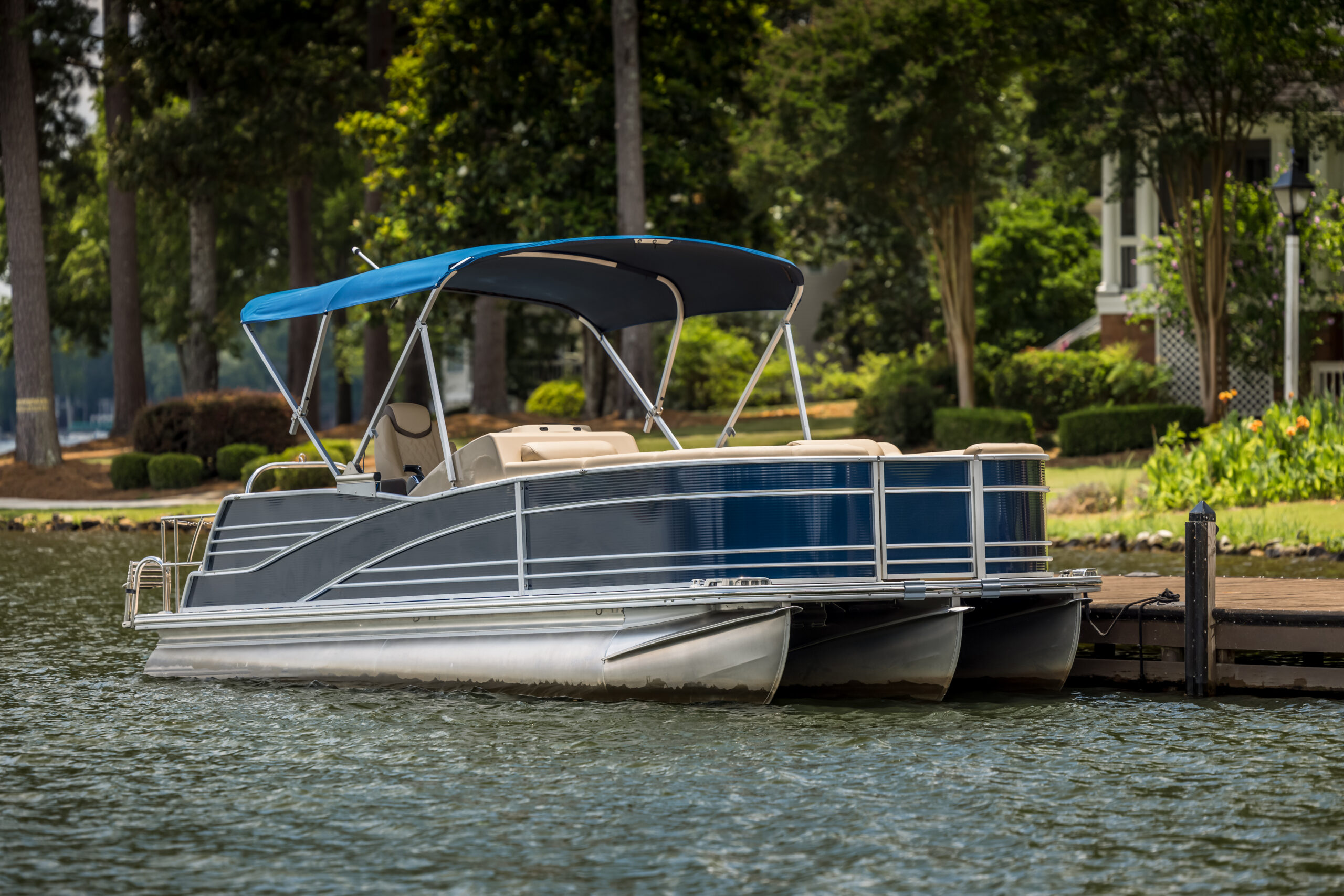 Pontoon boat at private dock on freshwater lake.