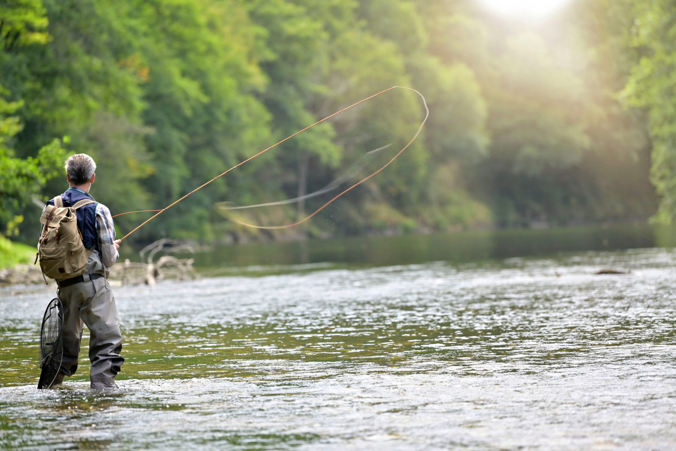 Angler fly fishing on a river near West Yellowstone, Montana.